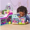 A young girl plays with a toy playset. Anteprima dell’immagine prodotto