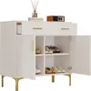 A white shoe cabinet with gold legs and handles, featuring two doors and two drawers, is shown against a white background. The doors are open, revealing shelves with shoes inside. Produktbild-Vorschau