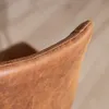 A close-up view of the top edge of a cognac-colored leather bar stool. Produktbild-Vorschau