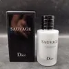 A bottle of Dior Sauvage Aftershave Balm and its packaging are displayed against a gray background. Produktbild-Vorschau