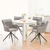 A dining set with a round white table and four gray chairs in a well-lit room. Voir les images du produit