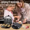 A mother and daughter are preparing donuts with a donut maker. The donut maker is open, showing freshly baked donuts and empty molds. Another donut maker is closed and on the table, along with some finished donuts and a cup of coffee. Náhled obrázku produktu