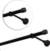 A close-up view of a black curtain rod with a mounting bracket and end cap. Anteprima dell’immagine prodotto