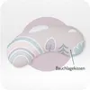 A baby floor pillow with a pastel rainbow and cloud pattern, presented on a light gray and white background with a pink circular overlay. Produktbild-Vorschau