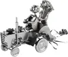 A metal sculpture of a wedding couple on a tractor, decorated with gifts and ribbons. Produktbild-Vorschau