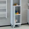 A tall, narrow white cabinet with a door slightly ajar, standing in a bathroom next to a white towel rack. Náhľad obrázku produktu