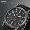 Close-up of a black men's wristwatch with a black fabric strap, showing the dial and some text. Produktbild-Vorschau