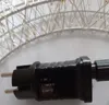 A close-up of a black power adapter with a dial and text labels, connected to a string of white lights. Produktbild-Vorschau