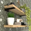 Two wooden shelves mounted on a patterned wall, decorated with plants and books. Produktbild-Vorschau