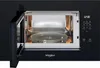 An open black Whirlpool microwave with the interior light on, showing the turntable and control panel. Voir les images du produit