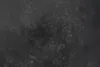A close-up texture of a dark gray surface with subtle lighter gray variations and fine lines resembling cracks or veins. Produktbild-Vorschau