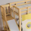 Close-up view of a wooden bunk bed with a slide and a yellow curtain. Produktbild-Vorschau