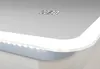 A close-up of a modern bathroom mirror with integrated LED lighting and a digital clock. Podgląd zdjęcia produktu