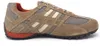 A side view of a single beige and orange athletic shoe against a white background. Produktbild-Vorschau