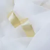 A close-up view of white sheer fabric with gold satin ribbon trim. Produktbild-Vorschau