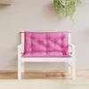 A pink cushion on a white bench against a light-colored wall with hanging plants. Produktbild-Vorschau