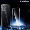 Two transparent phone cases are displayed against a dark, starry background with blue light effects. Produktbild-Vorschau