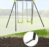 A swing set with two lime green swings is shown outdoors on a grassy field with trees in the background. A close-up of the swing set's foot is shown in a circular inset at the bottom right. Produktbild-Vorschau