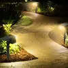 A pathway illuminated by solar-powered garden lights at night. Anteprima dell’immagine prodotto