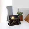 A tablet displaying a group of people in a dramatic scene, placed on a white surface next to a speaker and a potted plant. Anteprima dell’immagine prodotto