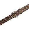 A close-up shot of a leopard-print belt with a silver buckle. Produktbild-Vorschau
