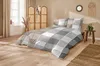 A bedroom scene with a bed made with a checkered duvet cover. Produktbild-Vorschau