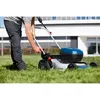 A person is mowing a lawn with a Bosch cordless lawnmower. Voir les images du produit