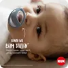 Close-up of a baby's face with a pacifier, with marketing text overlay. Náhľad obrázku produktu