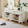 A white sideboard with two drawers and four doors is shown in a well-lit room. The doors and drawers are open, revealing the interior storage space. Decorative items like a lamp, a vase with a plant, and gift boxes are placed on top and inside the sideboar Produktbild-Vorschau