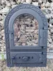 A cast iron stove door filled with rocks, set against a gabion wall. Náhľad obrázku produktu