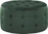 A dark green velvet ottoman with button tufting.