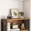 A close-up view of a rustic industrial-style wooden bookshelf with various decorative items on it. Anteprima dell’immagine prodotto