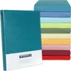 A stack of colorful fitted sheets is shown next to a teal fitted sheet in its packaging. Produktbild-Vorschau