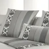 A close-up view of several pillows with a striped and floral pattern. Produktbild-Vorschau