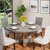 A dining table set with chairs in a dining room with a view of a garden. Anteprima dell’immagine prodotto