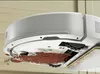 A close-up view of the underside of a robot vacuum cleaner, showing it cleaning up a pile of dirt. Anteprima dell’immagine prodotto