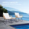 A rattan bistro set with white cushions is placed on a patio next to a swimming pool, with a scenic view of mountains and water in the background. Produktbild-Vorschau