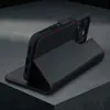 A black leather iPhone case with red stitching is shown in a studio setting, propped up to display its stand function. Produktbild-Vorschau