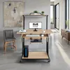 A modern home office setup featuring a standing desk with a computer, keyboard, mouse, and gaming accessories, next to a chair and artwork. Náhled obrázku produktu