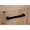 A close-up shot of a black handle on a wooden drawer or cabinet. Produktbild-Vorschau