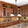 A kitchen scene with wooden cabinets, a sink, and a hanging light fixture. Produktbild-Vorschau