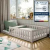 A child's bed with protective rails in a bedroom setting. Voir les images du produit