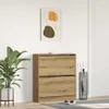 A wooden shoe cabinet with two drawers is shown in a room with a plant and an umbrella stand. Anteprima dell’immagine prodotto