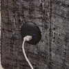 A close-up view of a USB charging port integrated into the side of a gray upholstered piece of furniture. Produktbild-Vorschau