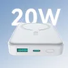 A white power bank with a wireless charging pad on top, set against a light blue background with radiating lines. Podgląd zdjęcia produktu