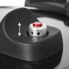A close-up view of a pressure cooker valve with a red cap and silver metal components, set against a dark black handle and a reflective surface. Podgląd zdjęcia produktu