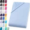 A light blue fitted sheet is displayed on a white background, with a swatch of other colors shown on the left. Produktbild-Vorschau