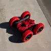 A red remote-controlled toy car with black accents and red wheels is shown on a concrete surface. Produktbild-Vorschau