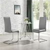 Two gray chairs and a glass table in a dining room with white brick walls and a window. Anteprima dell’immagine prodotto