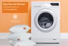 A washing machine is shown next to a stack of pillows, with text overlays indicating washability. Produktbild-Vorschau